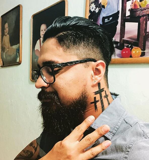 A Burst Fade haircut with a neck tattoo