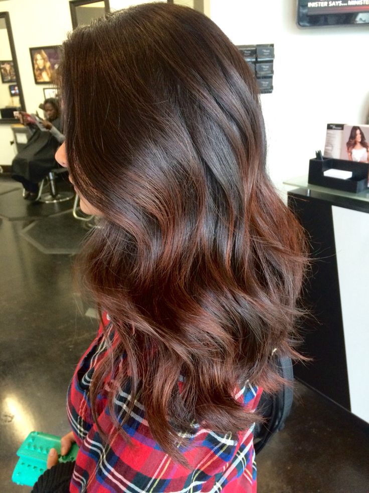 Low maintenance brunette hair with red balayage'd highlights 