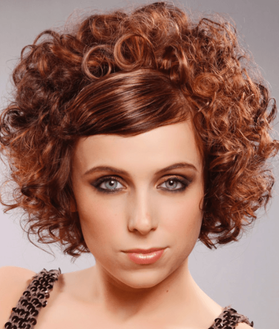 Curly brown hair with red highlights