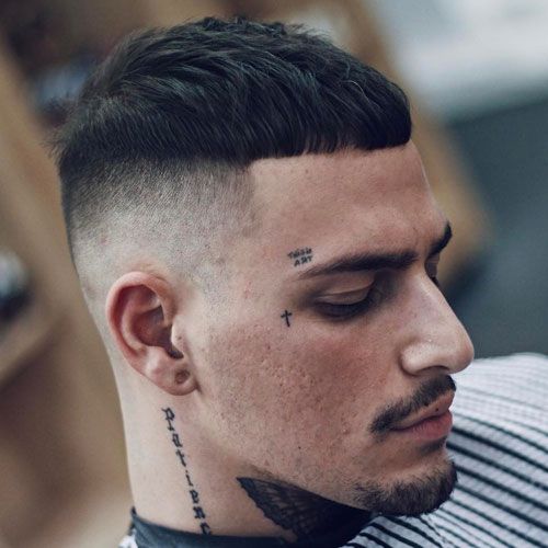 A French crop temp fade hairstyle with a neck tattoo