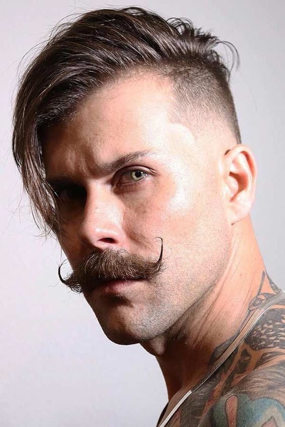 A high fade plus a disconnected undercut as well as a mustache