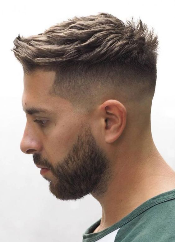 Short pompadour haircut with a burst fade