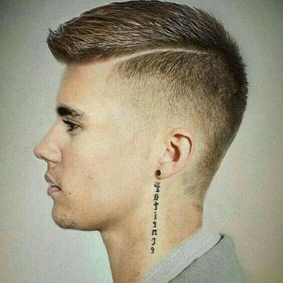Short side part haircut for thick hair plus a neck tattoo